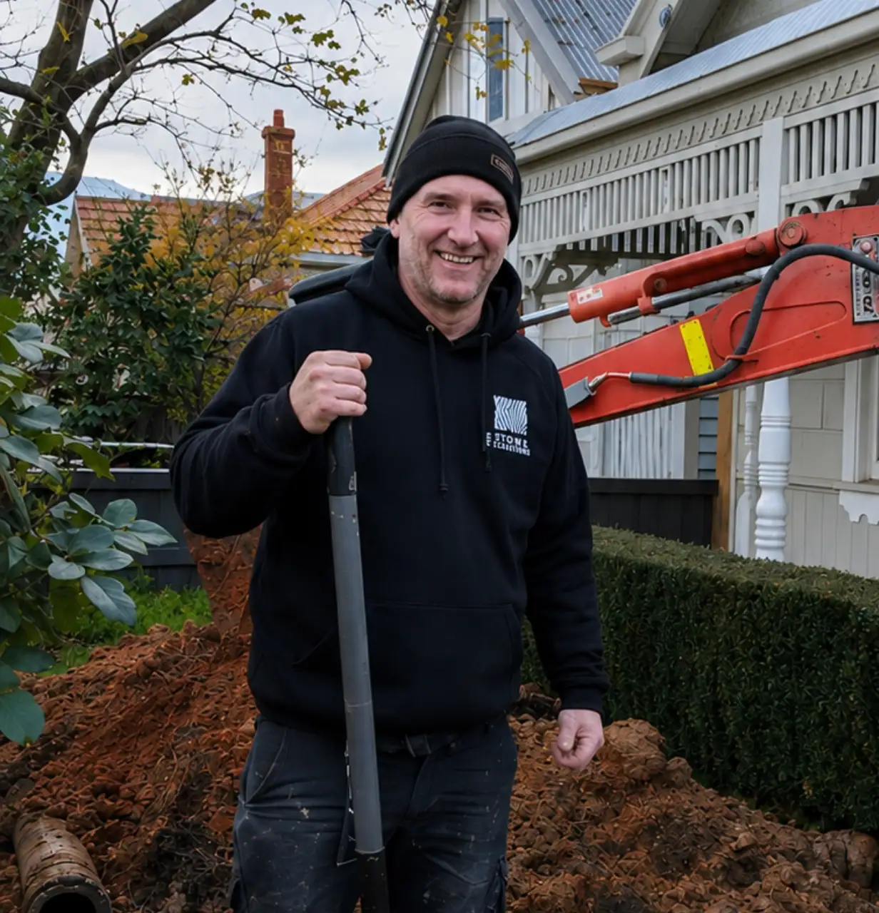 Kenny, plumber at Zebra Plumbing, standing on-site with a shovel during residential plumbing works.
